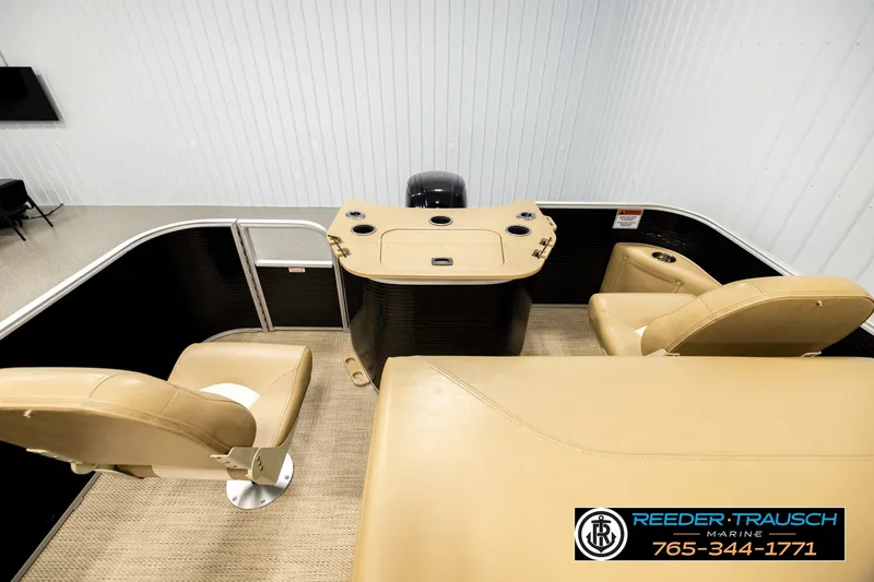 Slide: The Image of 2018 Bennington SX RF boat interior with beige seating and control panel in showroom. - 15