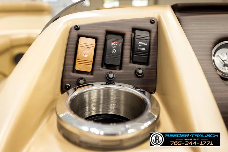 Slide: The Image of Control panel of 2018 Bennington SX RF boat with switches and cup holder. - 34