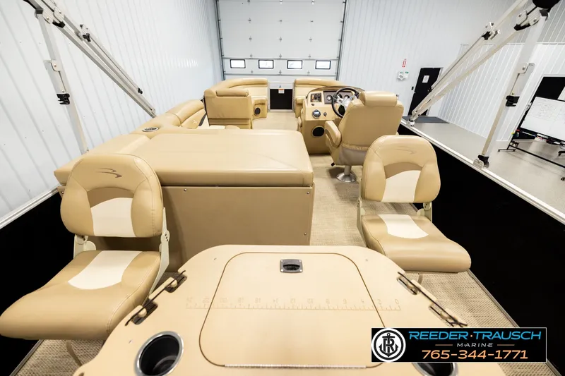 Slide: The Image of 2018 Bennington SX RF pontoon boat interior with beige seating and steering console. - 16