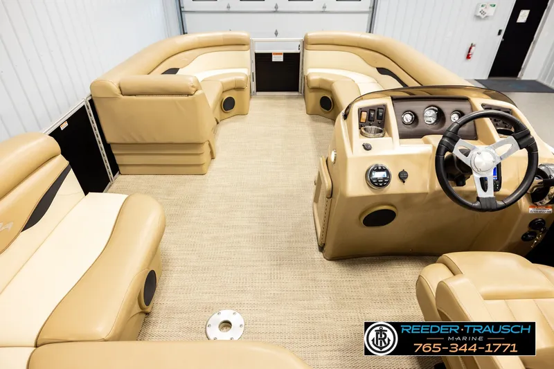 Slide: The Image of Interior of a 2018 Bennington SX RF pontoon boat with beige seating and steering console. - 17