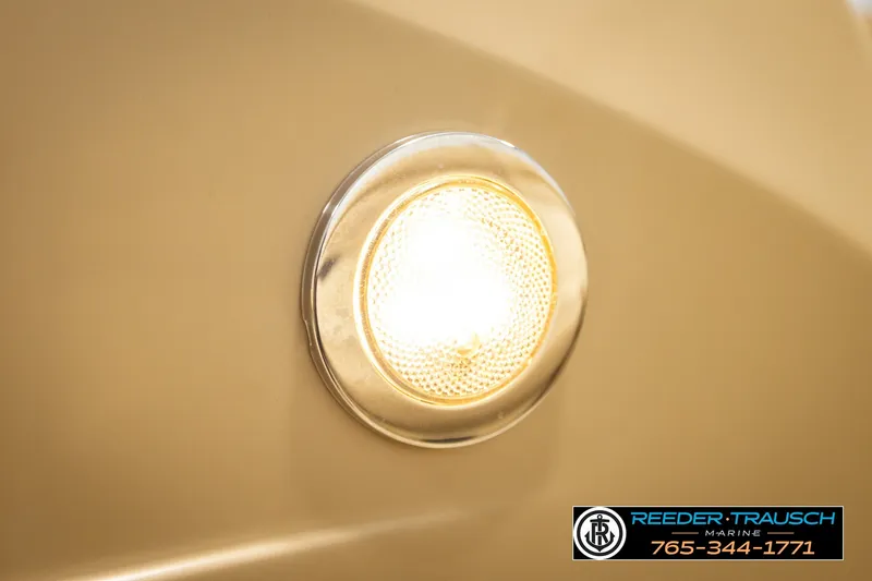 Slide: The Image of Close-up of a 2018 Bennington SX RF boat light, Reeder-Trausch Marine branding visible. - 43