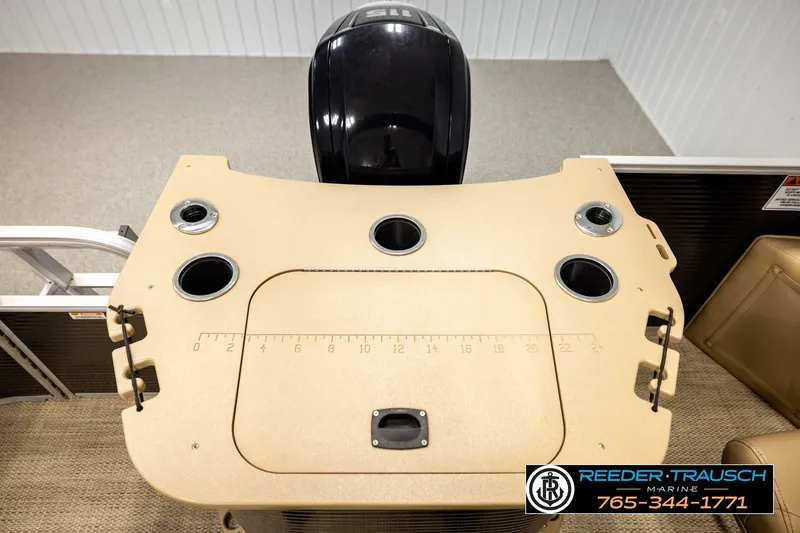 Slide: The Image of 2018 Bennington SX RF boat deck with cup holders and motor, Reeder Trausch Marine branding. - 46