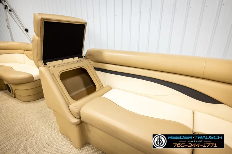 Slide: The Image of 2018 Bennington SX RF boat interior with tan seating and storage compartment. - 21