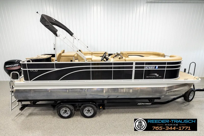 The Image of 2018 Bennington SX RF pontoon boat with Mercury engine on trailer in showroom. - 1