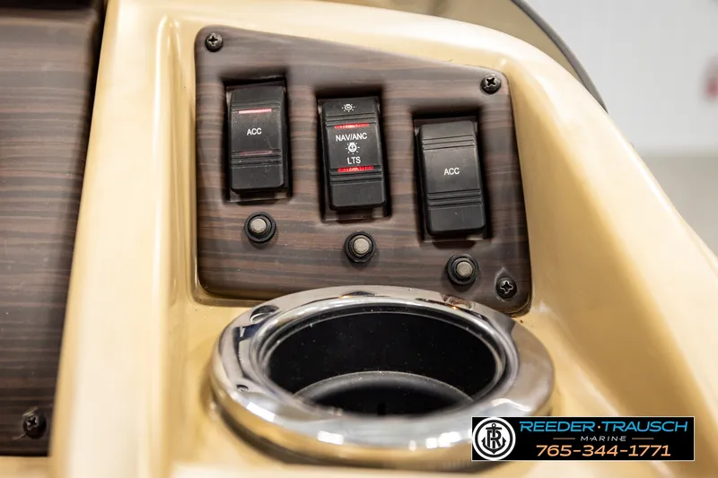 Slide: The Image of Control panel of a 2018 Bennington SX RF boat with switches and cup holder. - 37