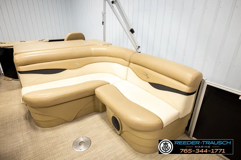 Slide: The Image of 2018 Bennington SX RF boat interior with beige seating and Reeder Trausch Marine branding. - 22