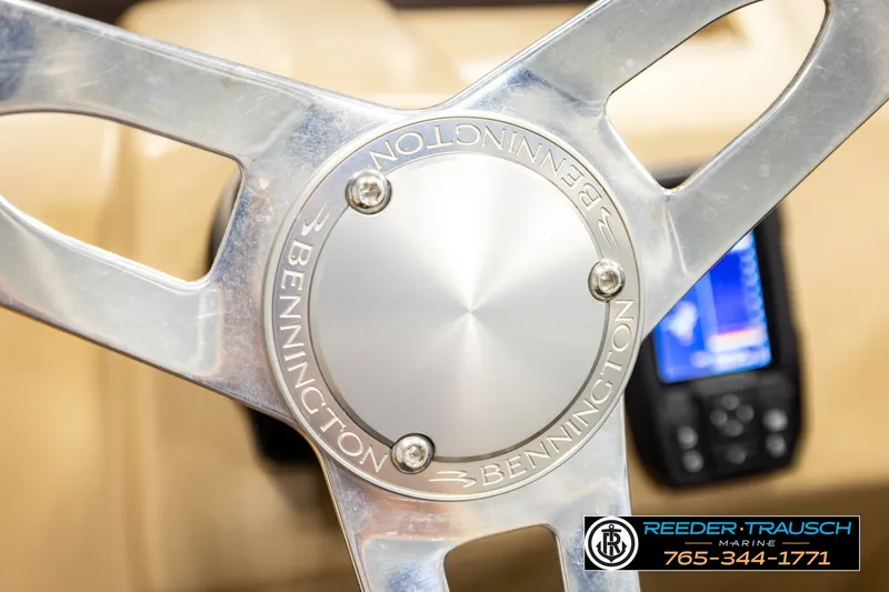 Slide: The Image of Steering wheel of a 2018 Bennington SX RF boat, featuring a sleek metallic design. - 31