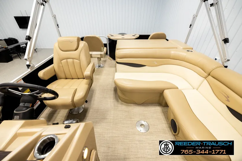 Slide: The Image of 2018 Bennington SX RF boat interior with beige seating and steering wheel. - 14