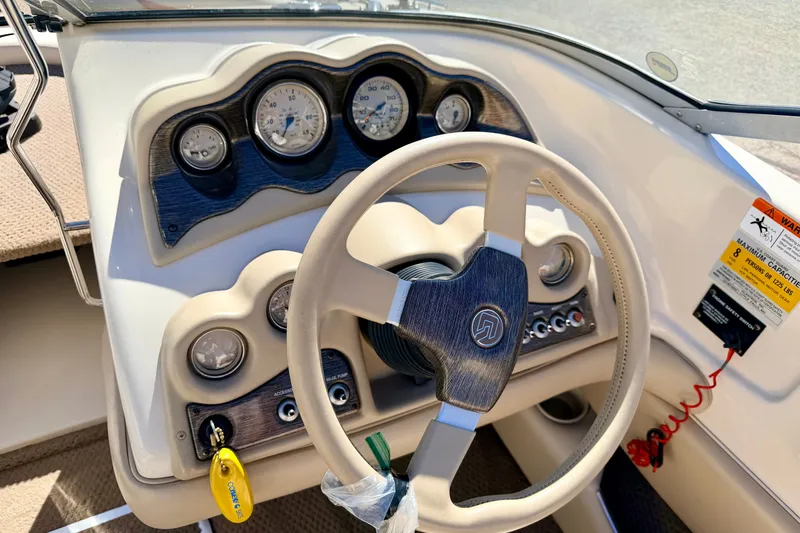 Slide: The Image of 2003 Glastron GX 180 Ski & Fish boat dashboard with steering wheel and gauges. - 33