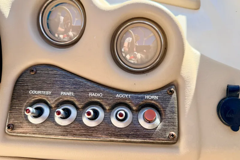 Slide: The Image of Dashboard controls of a 2003 Glastron GX 180 Ski & Fish boat, featuring switches and gauges. - 36