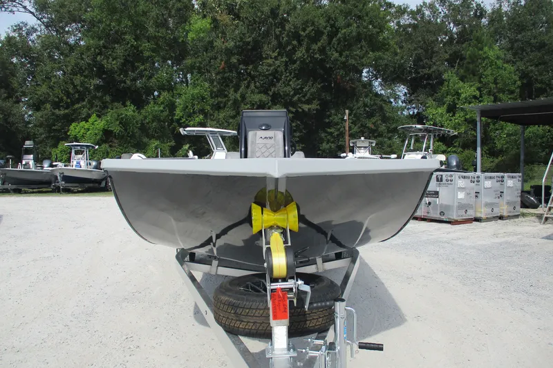 Slide: The Image of Avid 20 Rogue CC 2027 boat on trailer, parked outdoors with trees in background. - 8