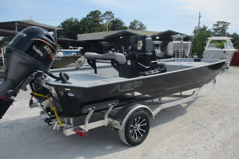 Slide: The Image of Avid 20 Rogue CC 2027 boat with Yamaha engine on trailer in outdoor setting. - 1