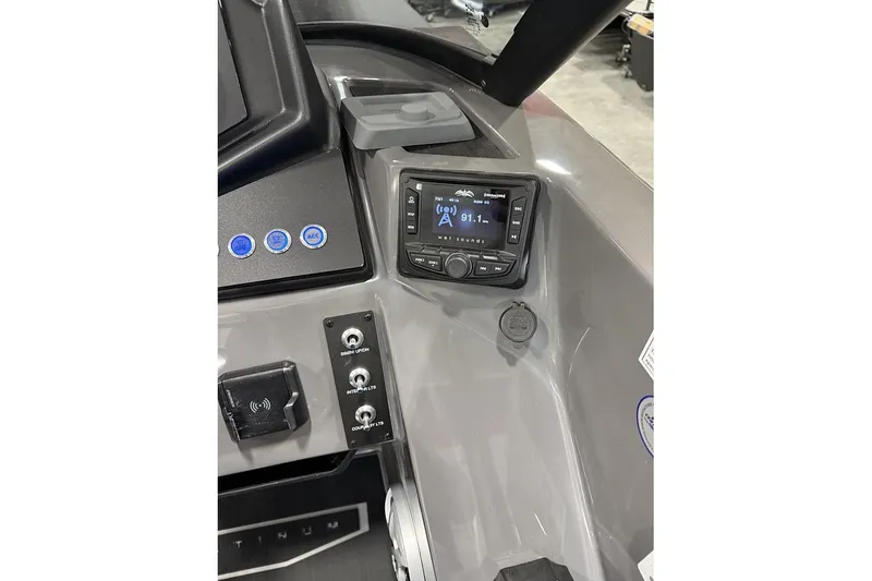 Slide: The Image of Dashboard of 2026 Sylvan L-5 Platinum boat with control panel and radio display. - 9