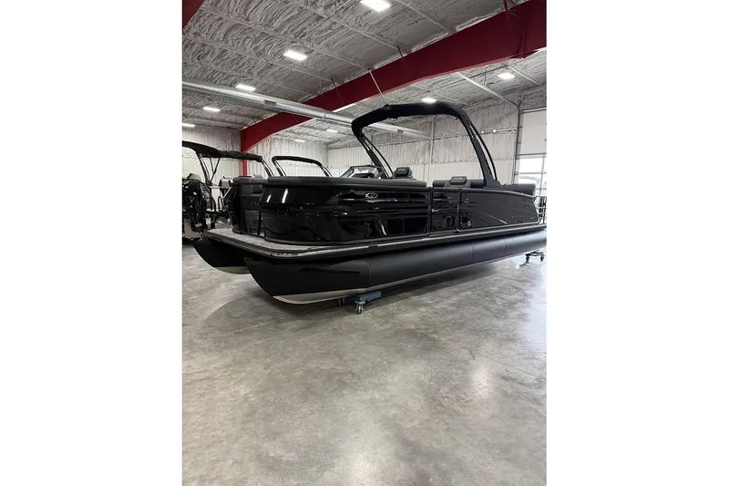The Image of 2026 Sylvan L-5 Platinum pontoon boat in showroom, sleek black design. - 1