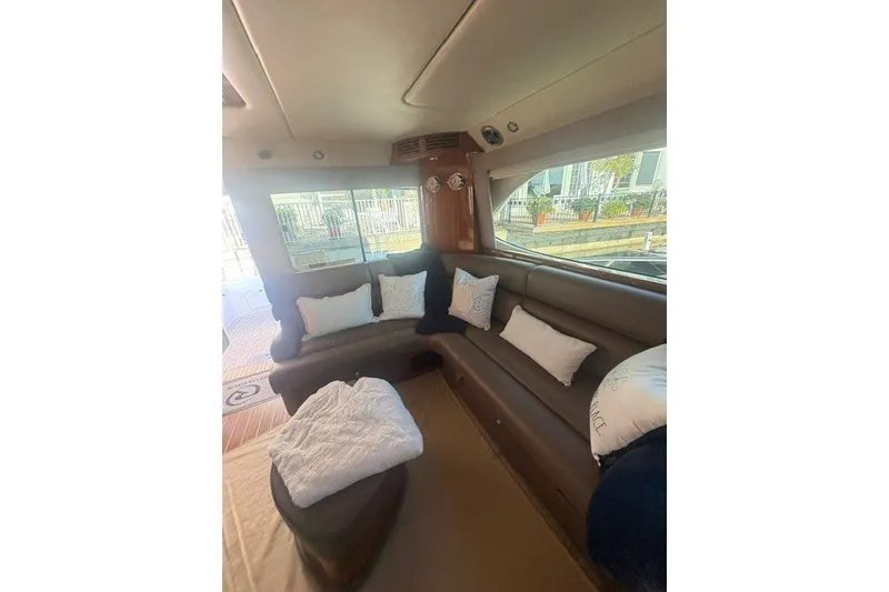 Slide: The Image of Luxurious interior of 2007 Riviera 51 Enclosed Flybridge with plush seating and cushions. - 10