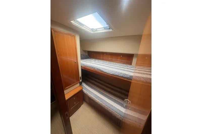 Slide: The Image of Interior cabin of 2007 Riviera 51 Enclosed Flybridge with bunk beds and wooden cabinetry. - 32