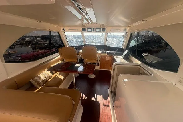 Slide: The Image of Luxurious interior of 2007 Riviera 51 Enclosed Flybridge yacht with leather seating and panoramic windows. - 21