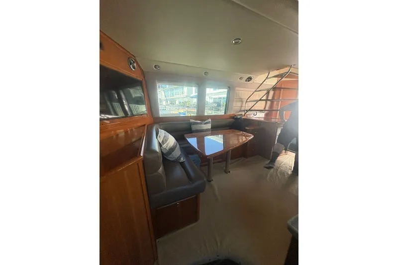 Slide: The Image of Interior of 2007 Riviera 51 Enclosed Flybridge with seating and table. - 11