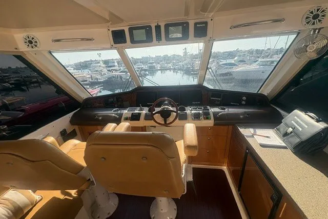 Slide: The Image of 2007 Riviera 51 Enclosed Flybridge helm with panoramic marina view. - 13