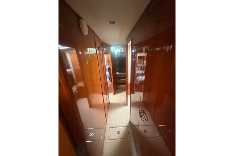Slide: The Image of Interior hallway of 2007 Riviera 51 Enclosed Flybridge yacht with wooden paneling. - 28