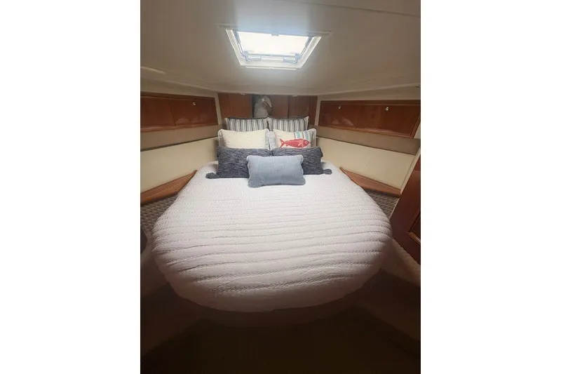 Slide: The Image of Luxurious bedroom interior of 2007 Riviera 51 Enclosed Flybridge yacht with plush bedding. - 27