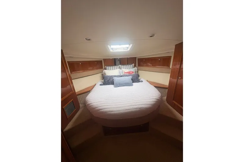 Slide: The Image of Luxurious bedroom interior of 2007 Riviera 51 Enclosed Flybridge yacht with cozy bedding. - 26