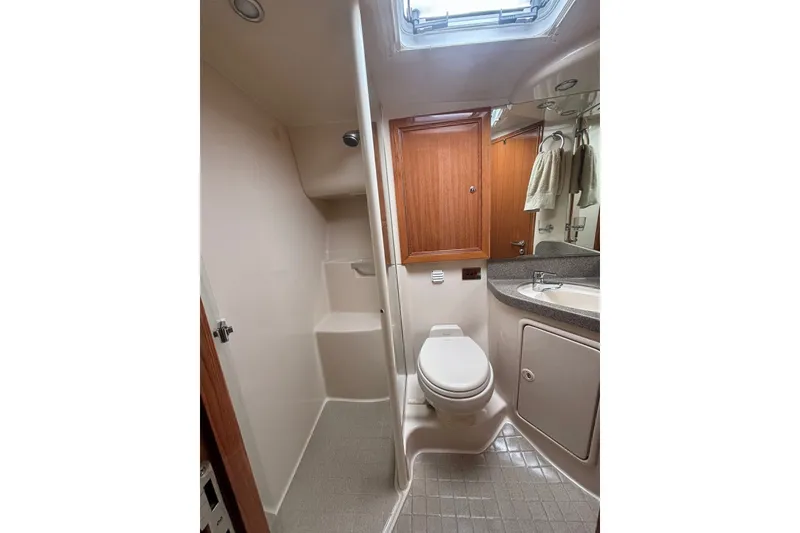 Slide: The Image of 2007 Riviera 51 Enclosed Flybridge bathroom with shower, toilet, and sink. - 16