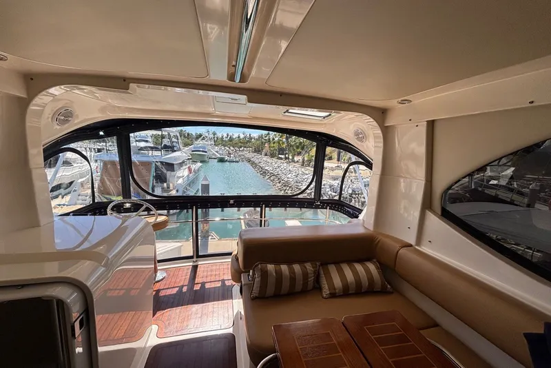 Slide: The Image of Interior view of 2007 Riviera 51 Enclosed Flybridge yacht, overlooking marina. - 14