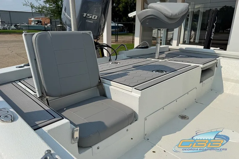 Slide: The Image of 2022 Avid 23 FS boat interior with gray seating and Yamaha 150 engine. - 17