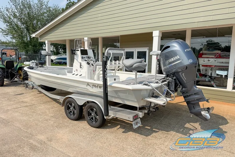Slide: The Image of 2022 Avid 23 FS boat with Yamaha 150 engine on trailer, parked outside dealership. - 3