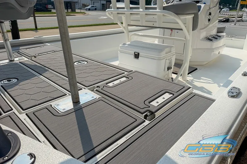 Slide: The Image of 2022 Avid 23 FS boat deck with seating and storage compartments. - 11