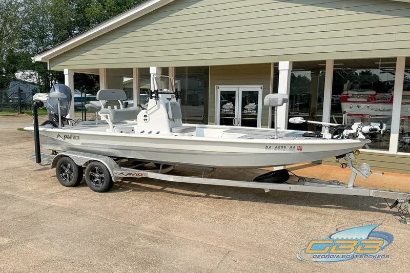 Slide: The Image of 2022 Avid 23 FS boat on trailer outside Georgia Boat Brokers showroom. - 4