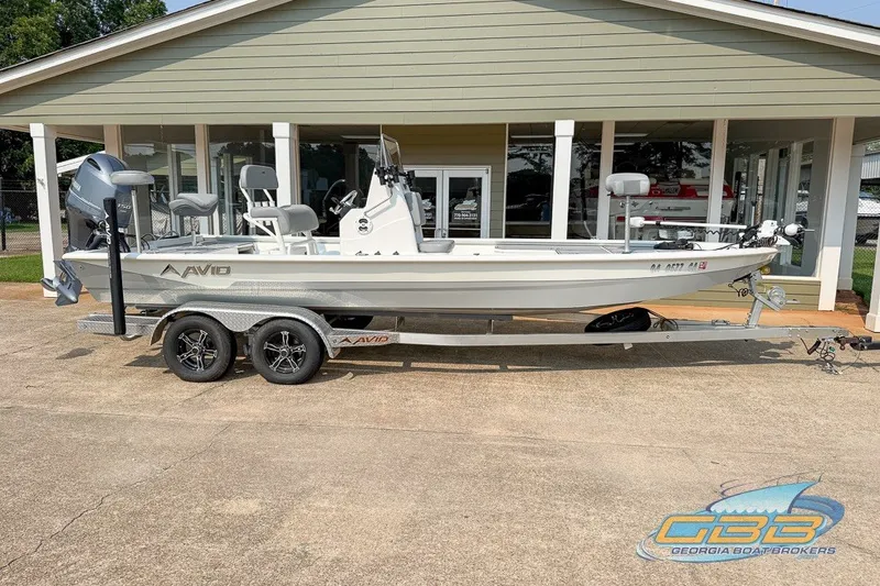 Slide: The Image of 2022 Avid 23 FS boat on trailer outside dealership. - 5