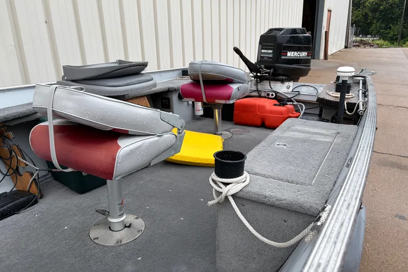 Slide: The Image of 1989 Lund 16 Pike SS boat interior with seats, motor, and equipment. - 4