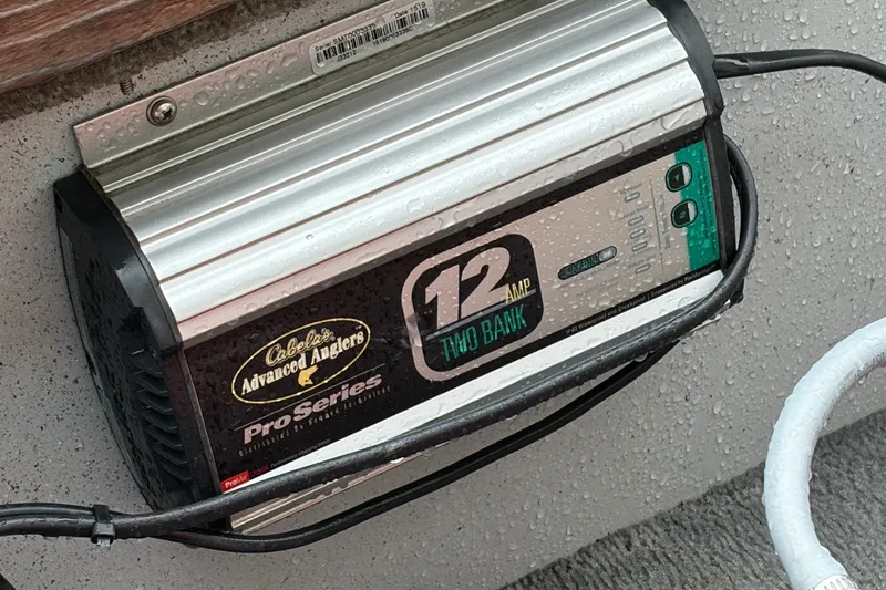 Slide: The Image of Cabela's Advanced Anglers Pro Series 12 Amp Two Bank charger on Lund 16 Pike SS boat. - 12