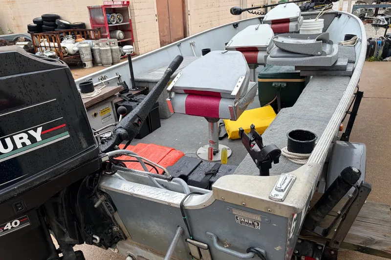 Slide: The Image of 1989 Lund 16 Pike SS boat with Mercury outboard motor, docked and equipped for fishing. - 10