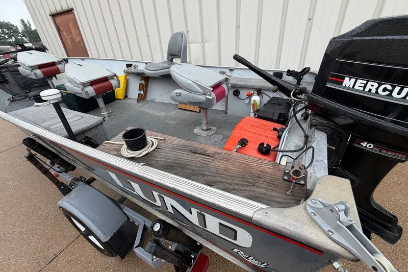 Slide: The Image of 1989 Lund 16 Pike SS fishing boat with Mercury engine, docked on trailer. - 13