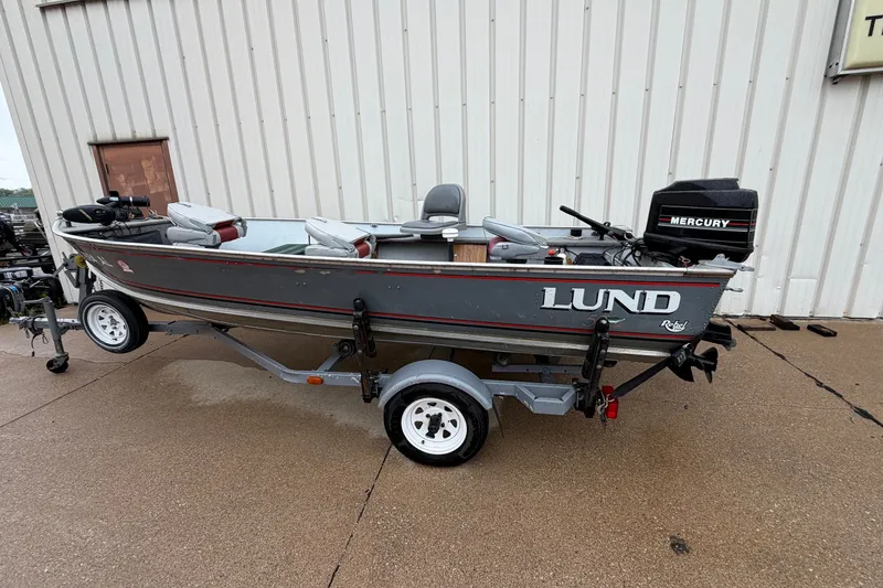 Slide: The Image of 1989 Lund 16 Pike SS fishing boat with Mercury outboard motor on trailer. - 1