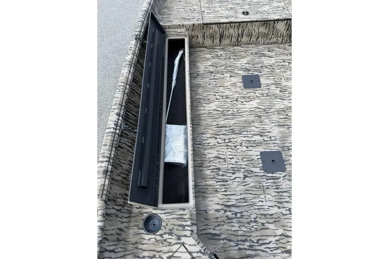 Slide: The Image of 2027 Excel 183 Tomahawk boat interior with open storage compartment and camouflage design. - 21