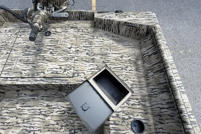 Slide: The Image of 2027 Excel 183 Tomahawk boat interior with camo pattern and open storage compartment. - 24
