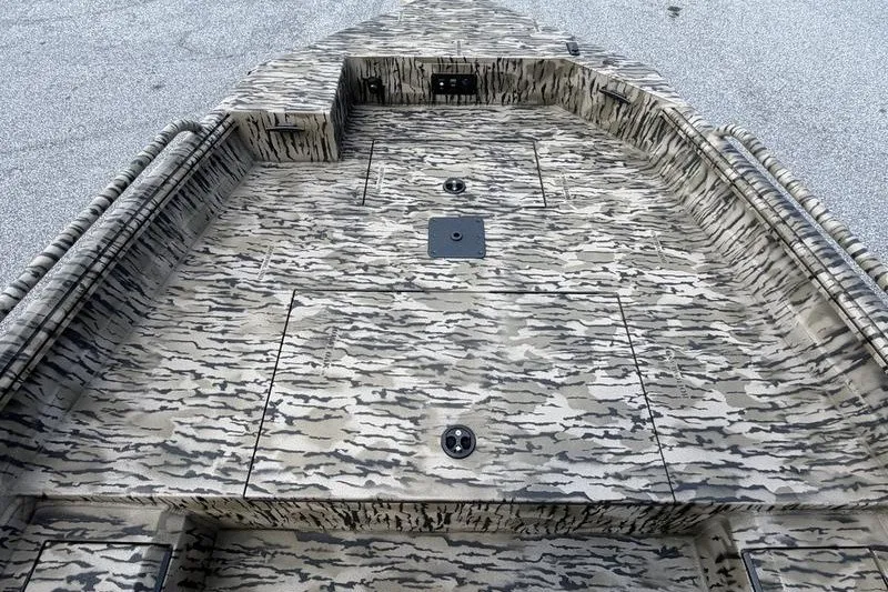 Slide: The Image of Camouflage-patterned deck of 2027 Excel 183 Tomahawk boat, featuring storage compartments. - 14
