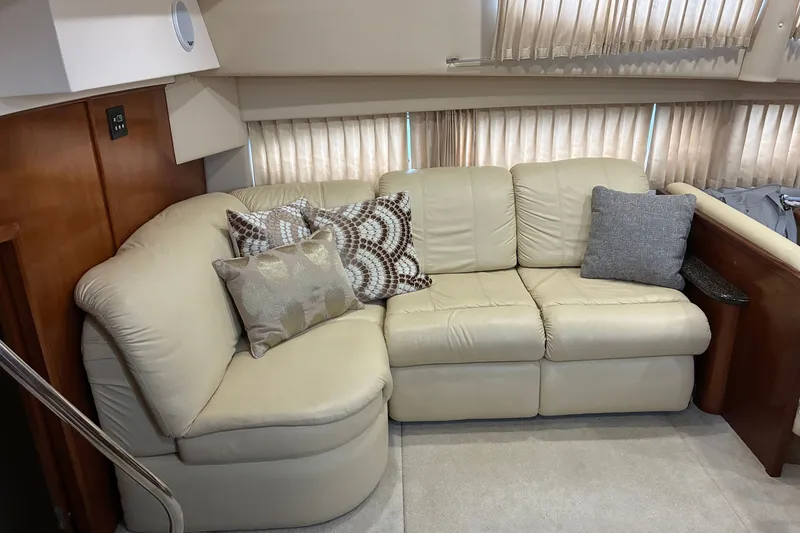 Slide: The Image of Luxurious beige leather sofa with decorative pillows in a 2003 Carver 366 Motor Yacht interior. - 14