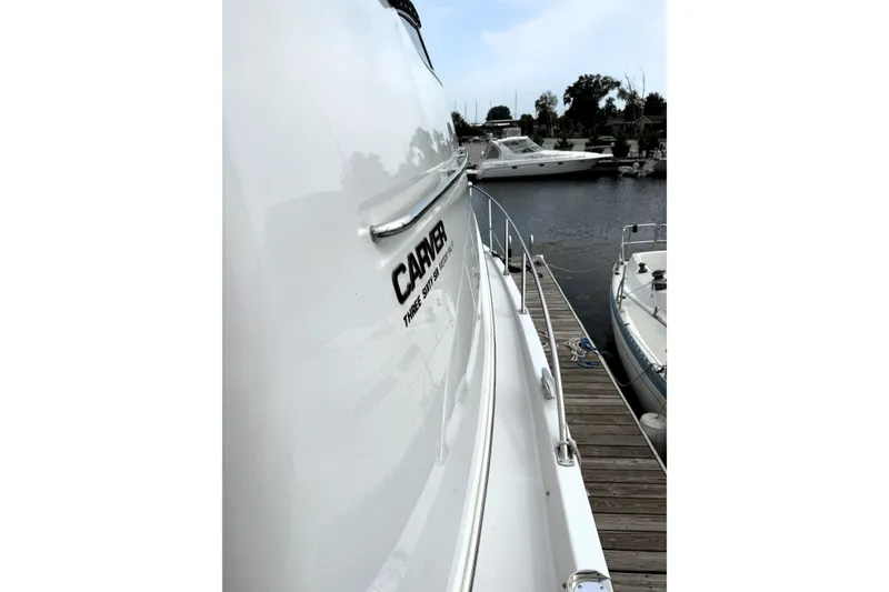 Slide: The Image of 2003 Carver 366 Motor Yacht docked at marina, side view. - 24