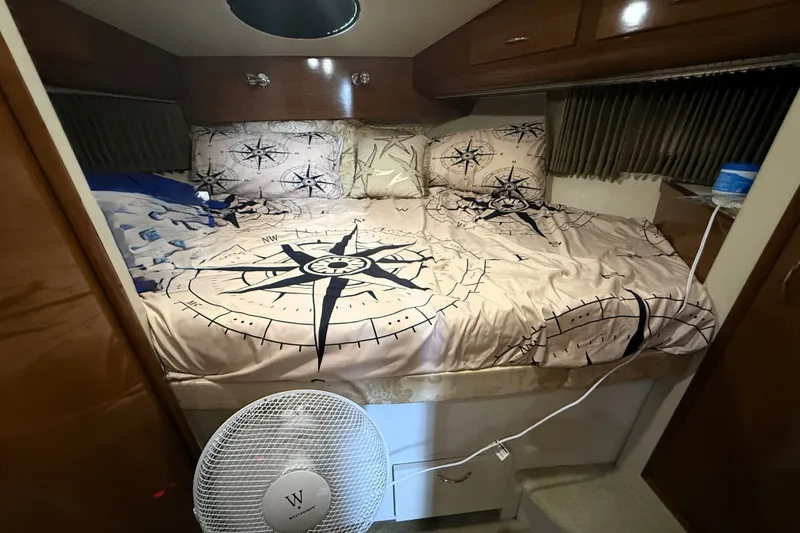 Slide: The Image of Cozy bedroom in 2003 Carver 366 Motor Yacht with nautical-themed bedding. - 21