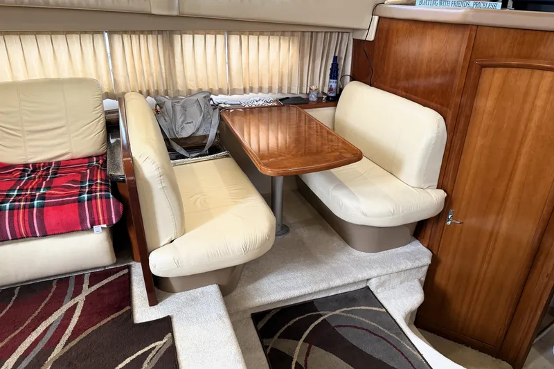 Slide: The Image of Interior of 2003 Carver 366 Motor Yacht with cozy dining area and plush seating. - 15