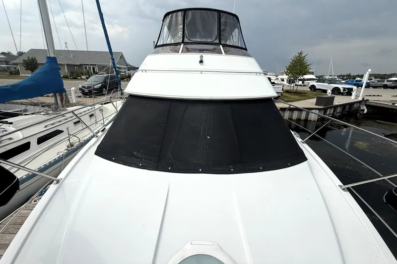 Slide: The Image of 2003 Carver 366 Motor Yacht docked at marina, showcasing sleek design and spacious deck. - 25