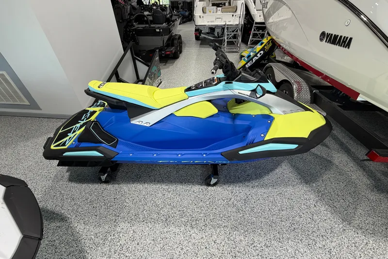The Image of 2026 Yamaha WaveRunner JetBlaster PRO 3-Up in showroom, vibrant blue and yellow design. - 1