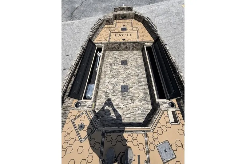 Slide: The Image of Excel 183 Tomahawk 2027 boat deck with hexagonal pattern and storage compartments. - 19