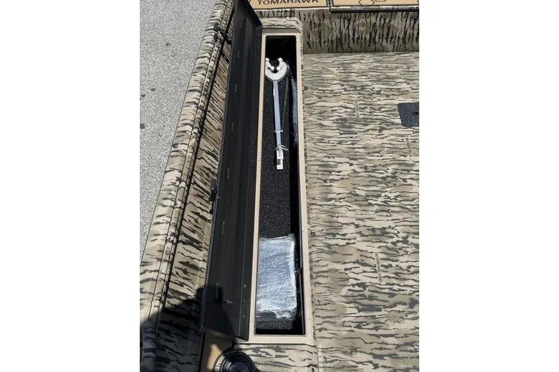 Slide: The Image of Open storage compartment in 2027 Excel 183 Tomahawk boat, featuring camouflage design. - 20