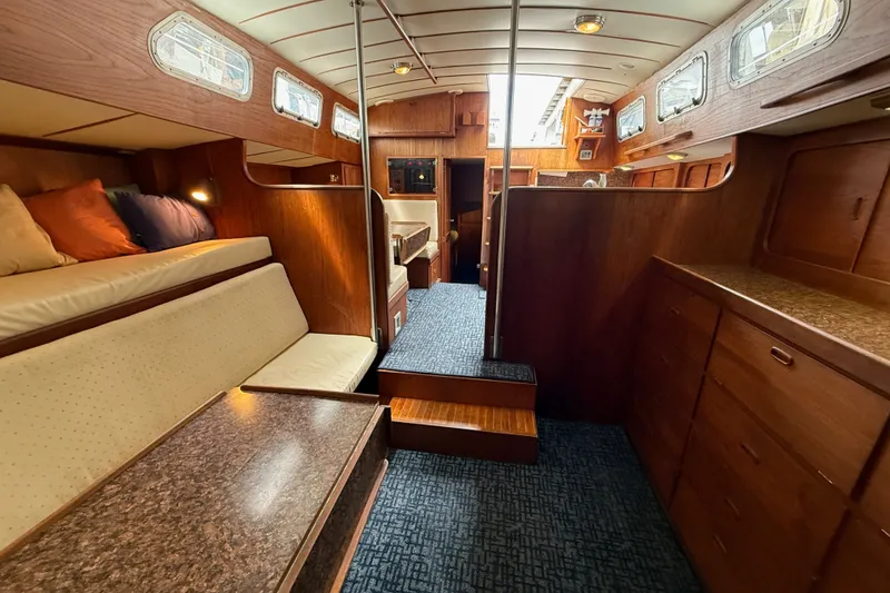 Slide: The Image of Interior of a 1974 Spencer 53 yacht with wood paneling and cozy seating. - 25